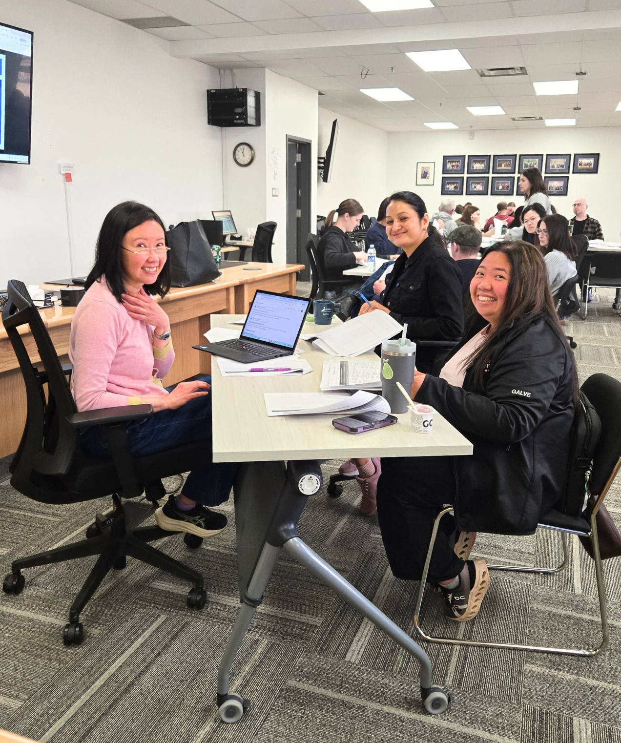 Three teachers working together at a table during a professional development session